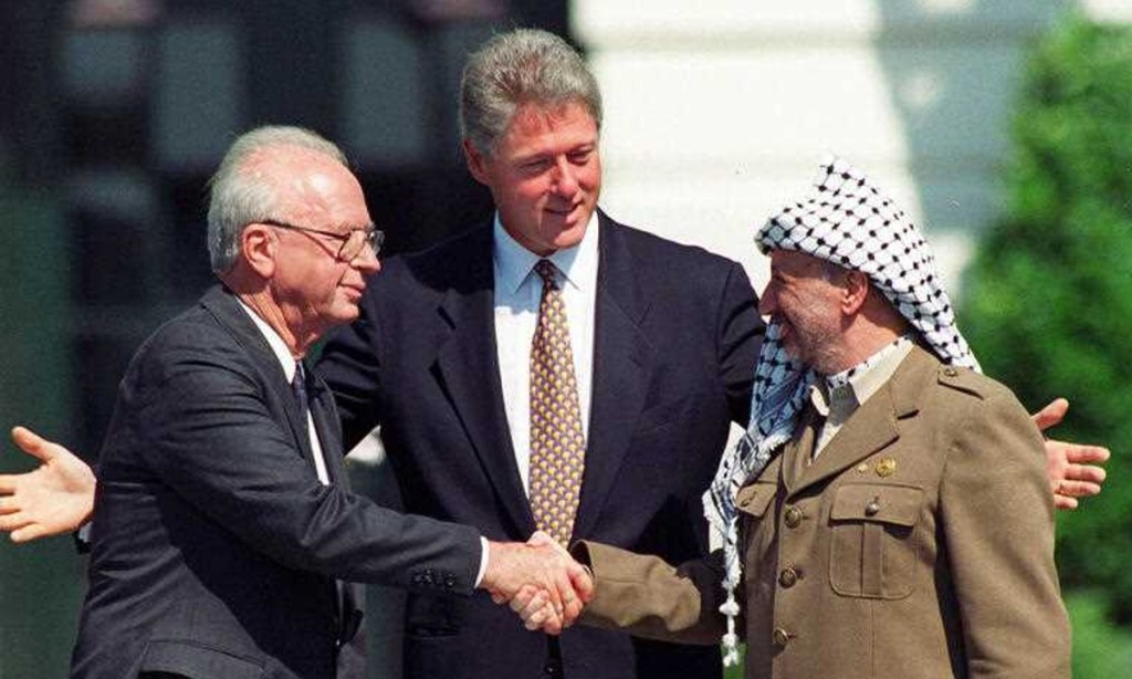 Israeli Prime Minister Yitzhak Rabin, left, and Palestinian leader Yasser Arafat shake hands marking the signing of the peace accord between Israel and the Palestinians, in Washington, Sept. 13, 1993. Photo: AP/Ron Edmonds