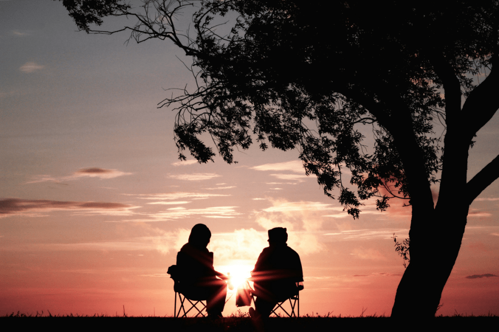 It could pay to work less as you wind down towards retirement. Photo: Photo by <a href="https://unsplash.com/@harlimarten?utm_content=creditCopyText&utm_medium=referral&utm_source=unsplash">Harli  Marten</a> on <a href="https://unsplash.com/photos/silhouette-of-two-person-sitting-on-chair-near-tree-M9jrKDXOQoU?utm_content=creditCopyText&utm_medium=referral&utm_source=unsplash">Unsplash</a>
  