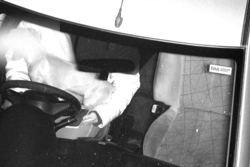 A mobile phone camera captures a driver using their phone. Photo: SA Police