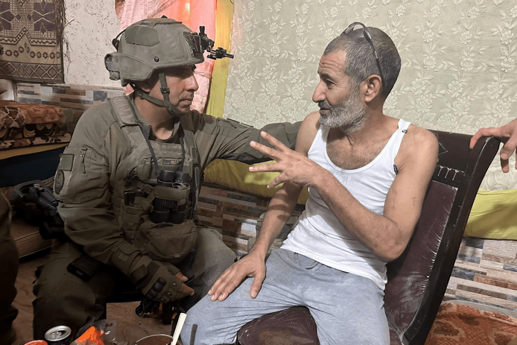 Qaid Farhan Alkadi talks after his rescue with 162nd Division commanding officer, Brig. Gen. Itzik Cohen. Photo: Israeli Defence Forces