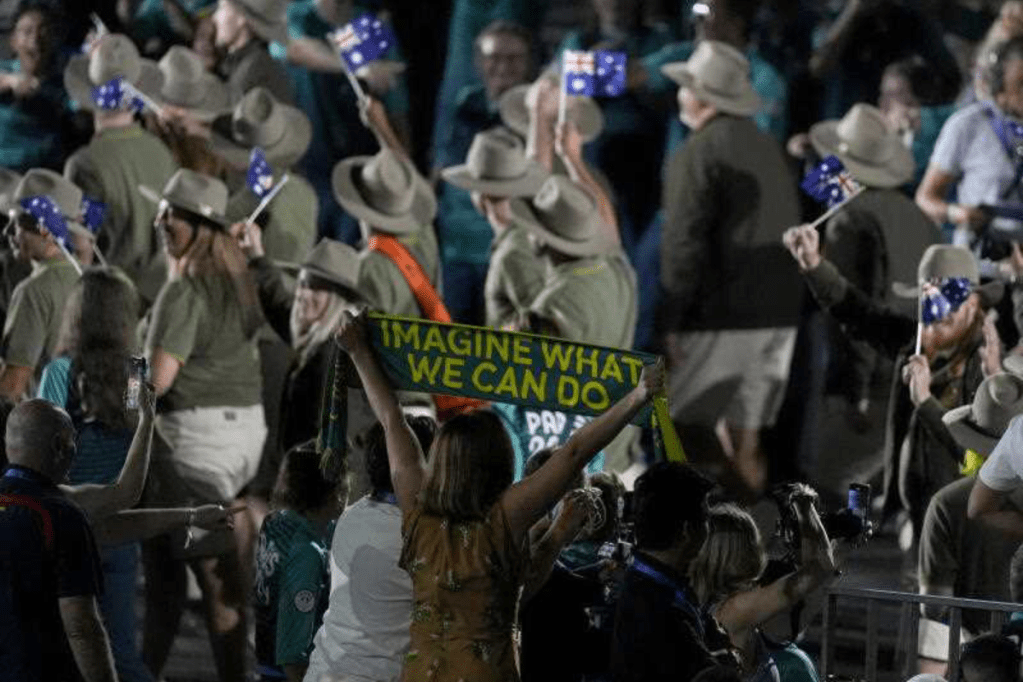 A spectator holds up a scarf with Imagine What We Can Do as members of Team Australia arrive at the opening ceremony of the Paris 2024 Olympic Games at the Place de la Concorde. Photo: Andrew Matthews/PA Wire